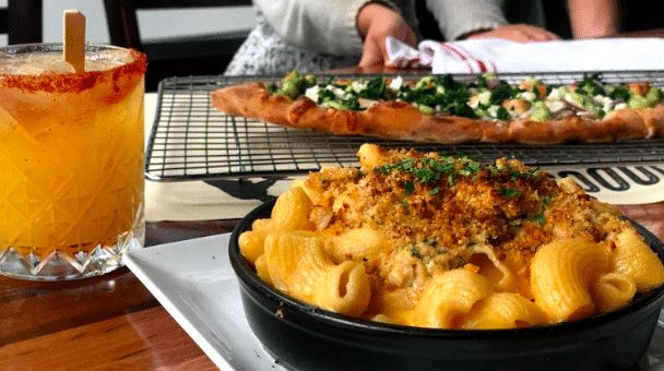 Happy Hour portion of Original Mac and 4 Cheeses - Housecrafted sourdough pasta, Pike Place Market Beecher's Flagship, reggiano, Grande whole milk mozzarella, Farmstead fontina, parsley. Vegetarian. Champagne Mango Margarita