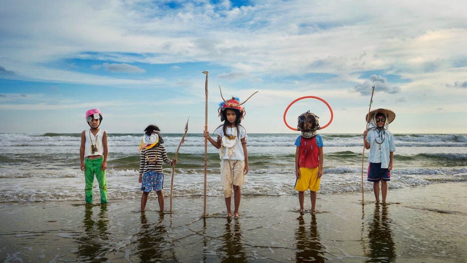 Image of 5 children standing in front of the ocean. They are dressed in playful underwater explorer costumes. Image courtesy of the Seattle art museum website.