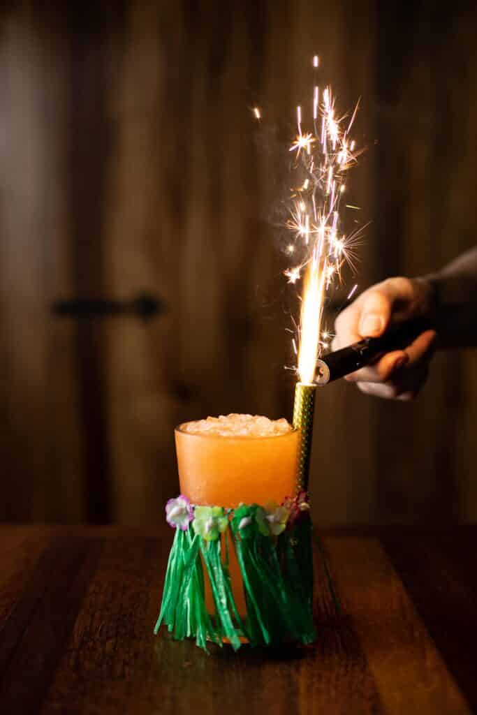 A Bar Boss™ Bourbon punch with Aperol, coconut rum and a blend of tropical juices. Sparkled tableside