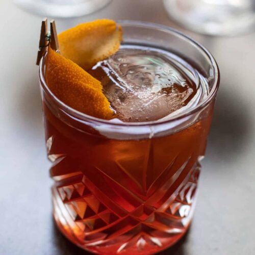 Smoked Manhattan made with Savor Spear® Bourbon, Mulassano Rosso, and brandied cherries, served tableside with a charred oak aroma.